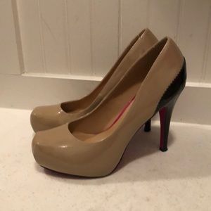 Tan and black patent leather pumps